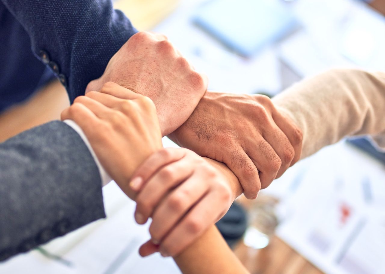 person in black long sleeve shirt holding persons hand